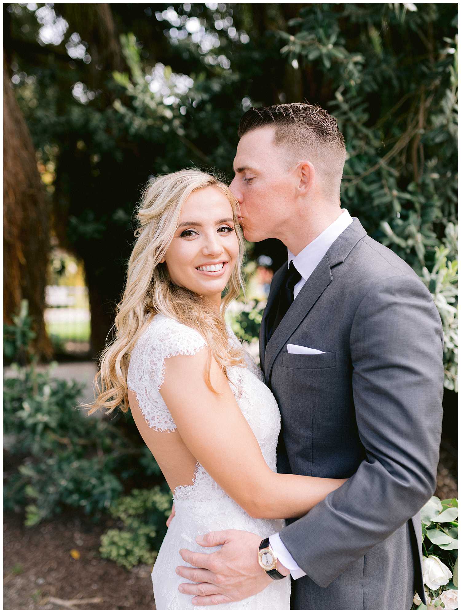 Mitchell kissing Kelsey before their botanical garden elopement.