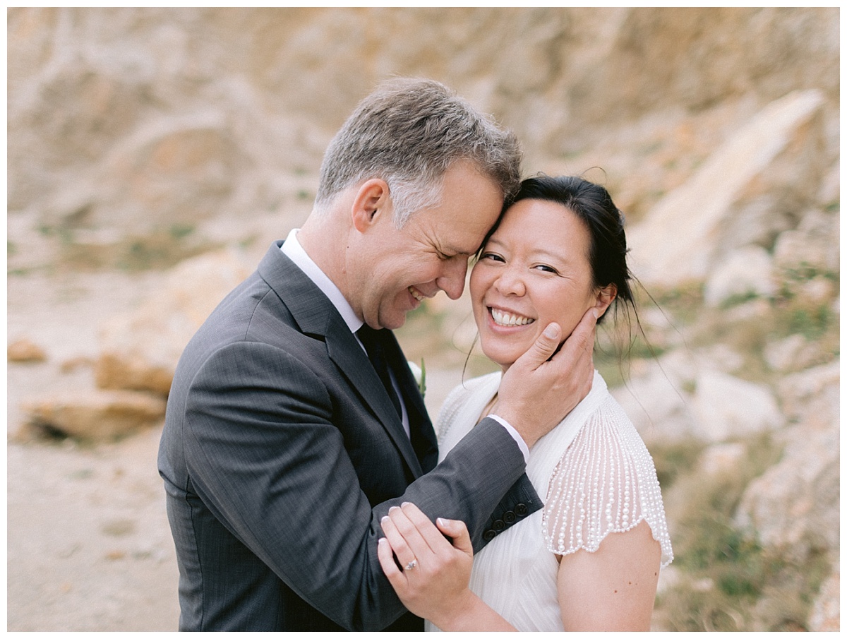 Newlywed couple smiling on the after getting married on the beach in the San Francisco Bay Area
