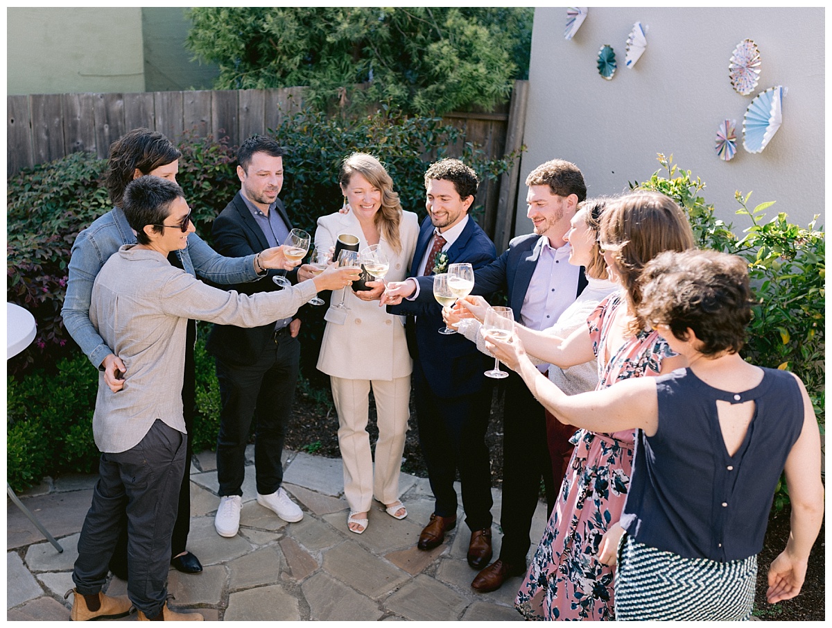 Cheers to the happy couple at their backyard elopement wedding