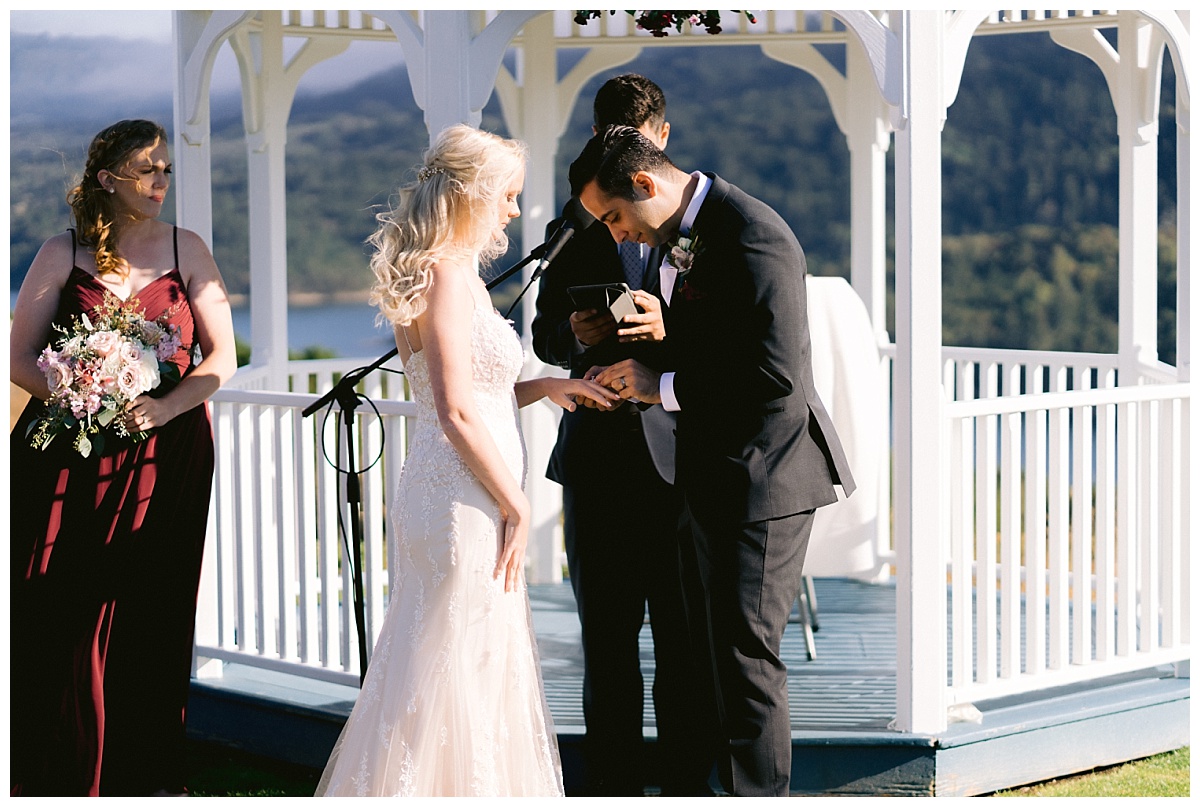 Niv places Alyssa's wedding ring on her finger