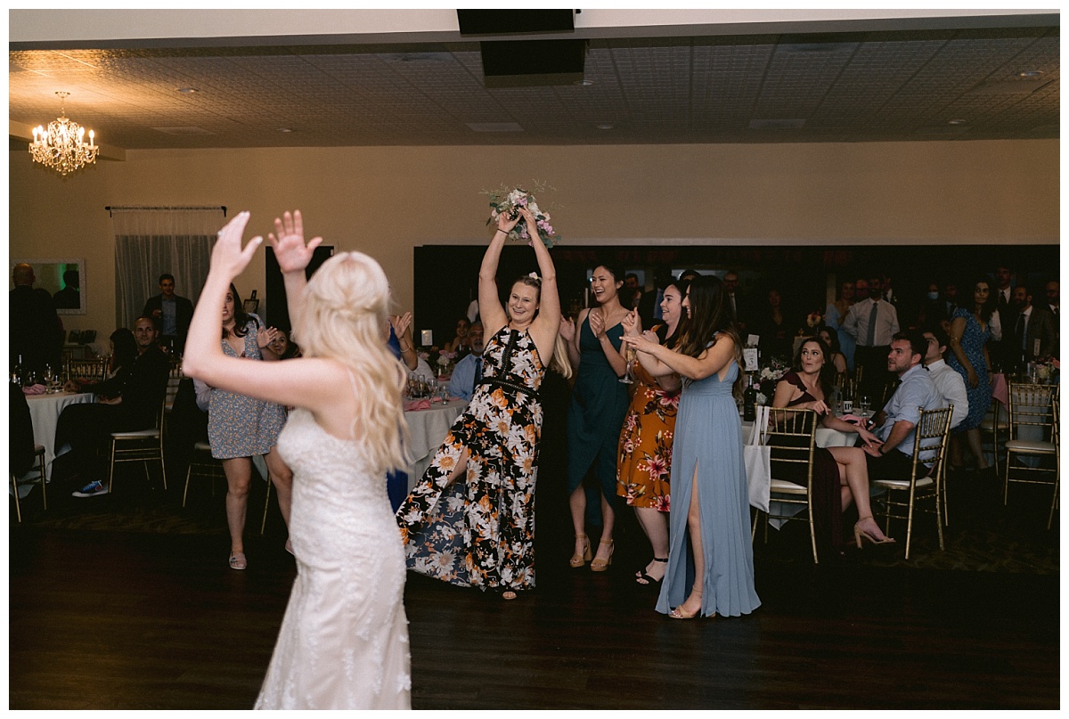 wedding guest catching the bridal bouquet