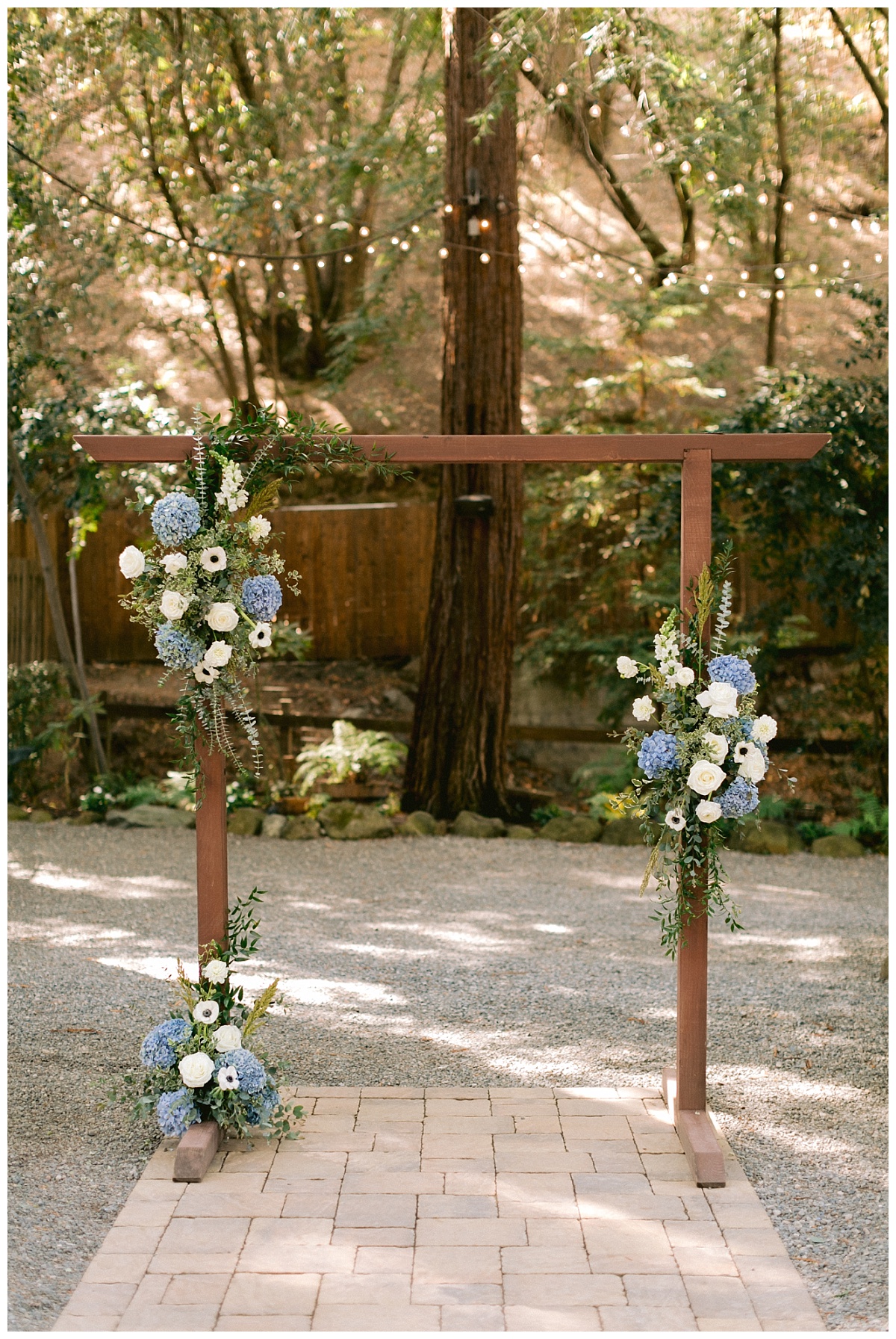 Wedding arch decorated with blue and white wedding florals