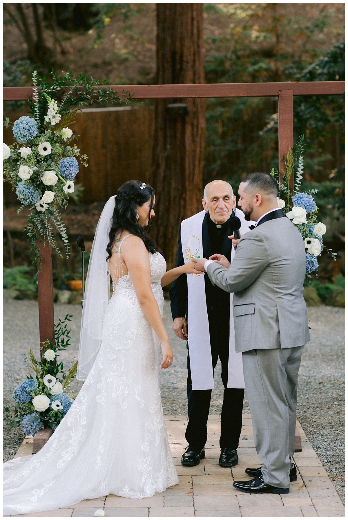 Groom places brides wedding her on her ring finger