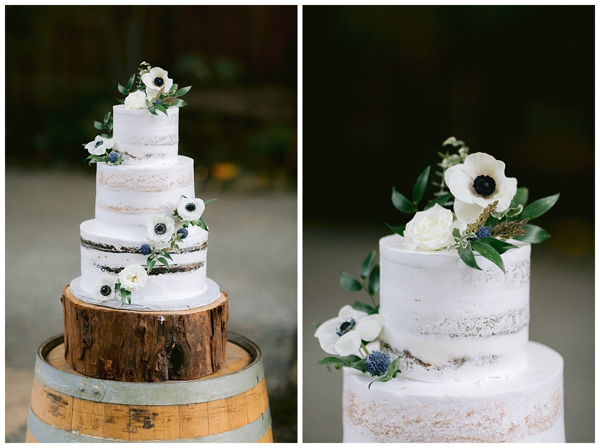 Three tiered fresh flower decorated wedding cake on wood slice pedestal