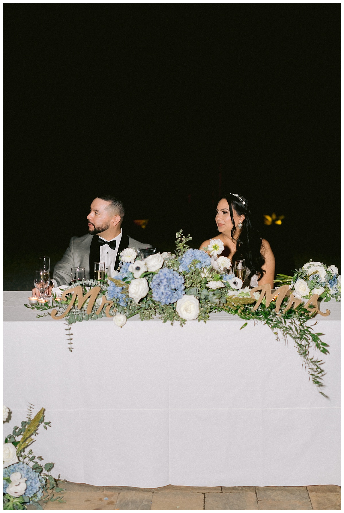 Liliana and Cesar listening to wedding speeches