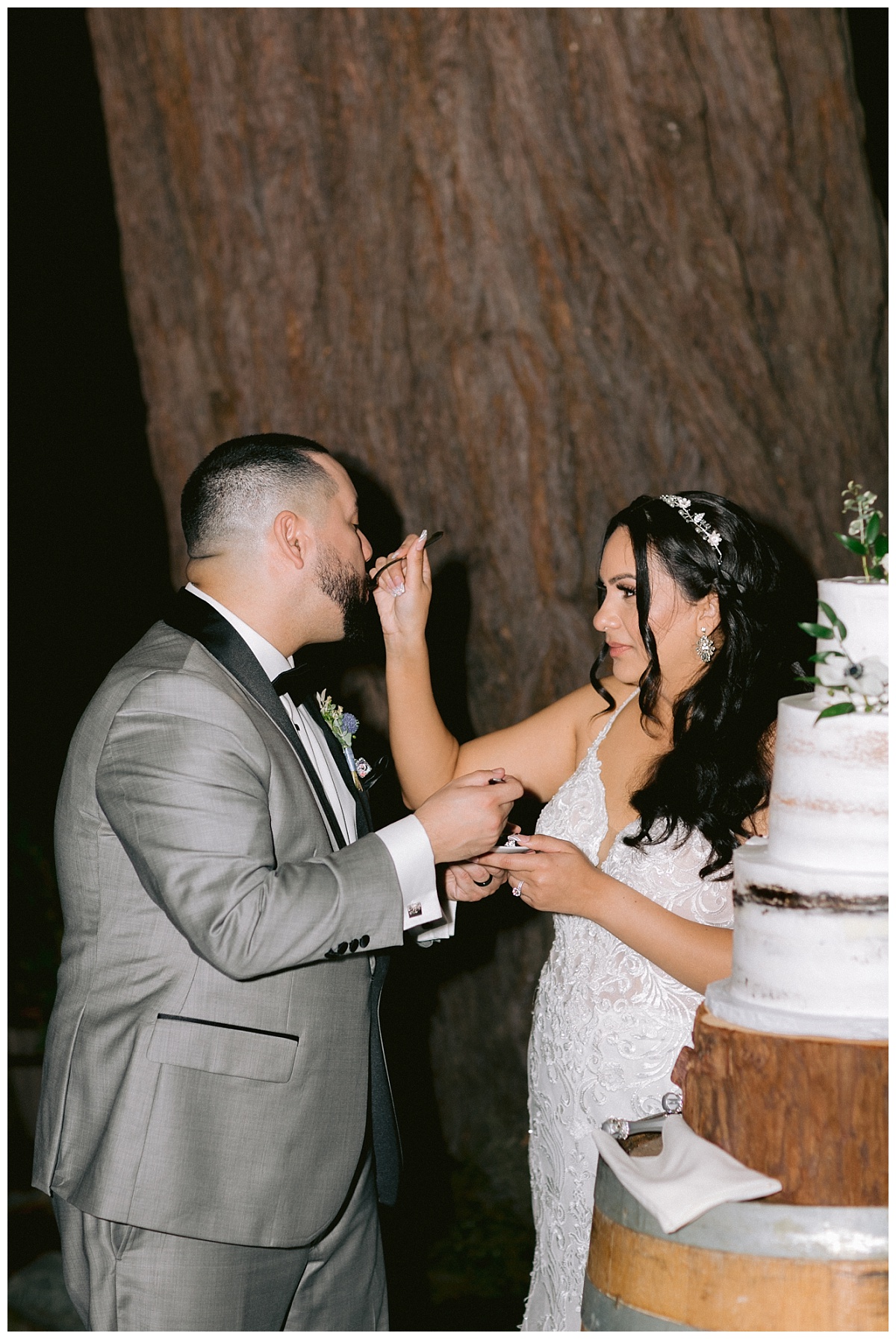 Bride feeds groom wedding cake
