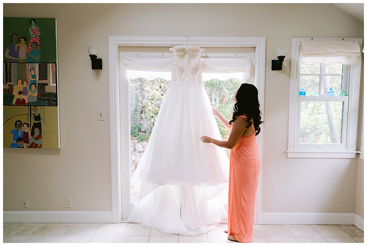 Brianna admiring her wedding dress