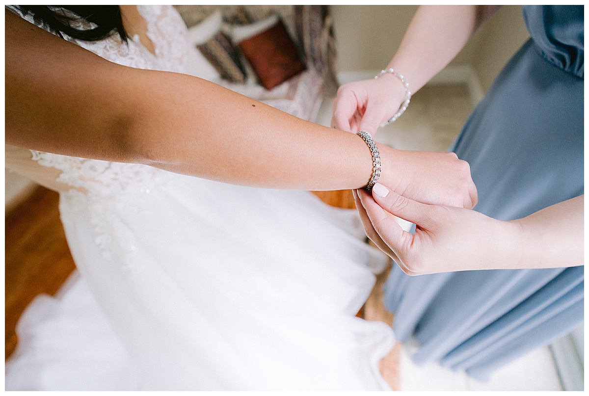 Brianna putting on her bridal jewelry