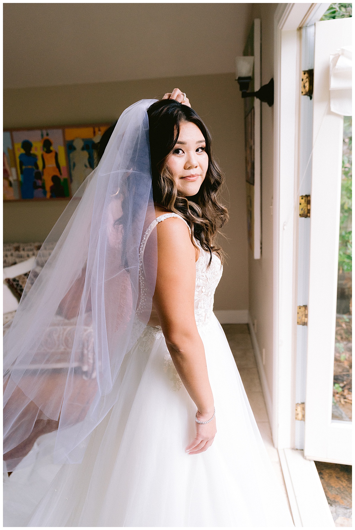 Brianna putting on her bridal veil