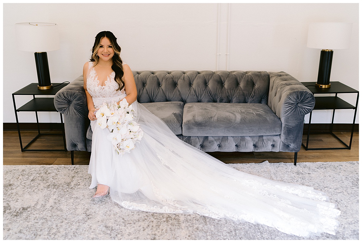Keyla, sitting, with her bridal bouquet