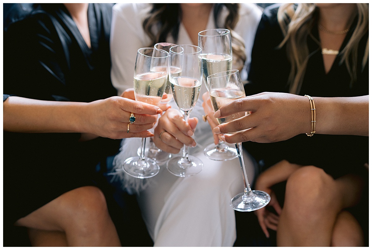 Bridal party cheers with champagne