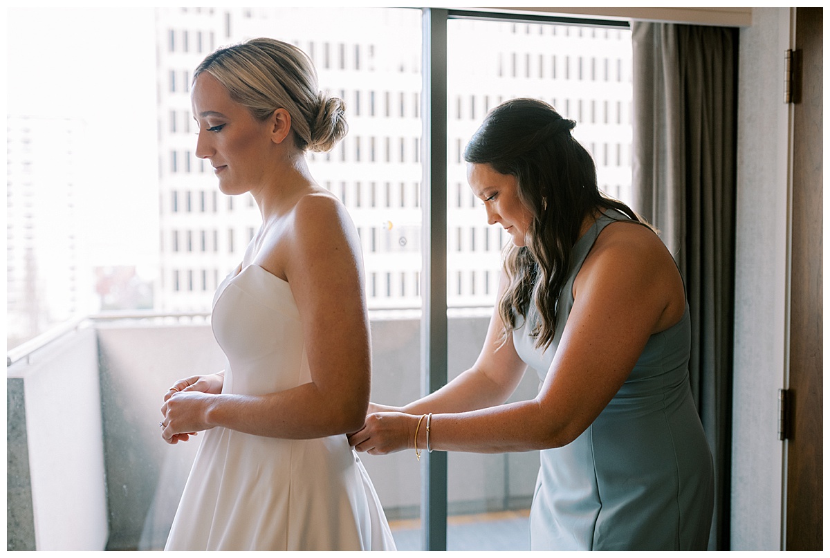 Susie putting on her wedding dress for the Golden Gate Club wedding