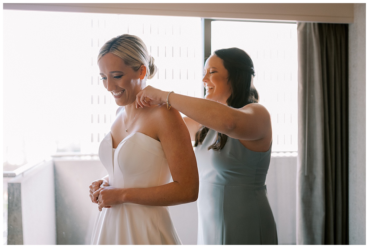 Susie getting help putting on her bridal jewelry for the Golden Gate Club wedding