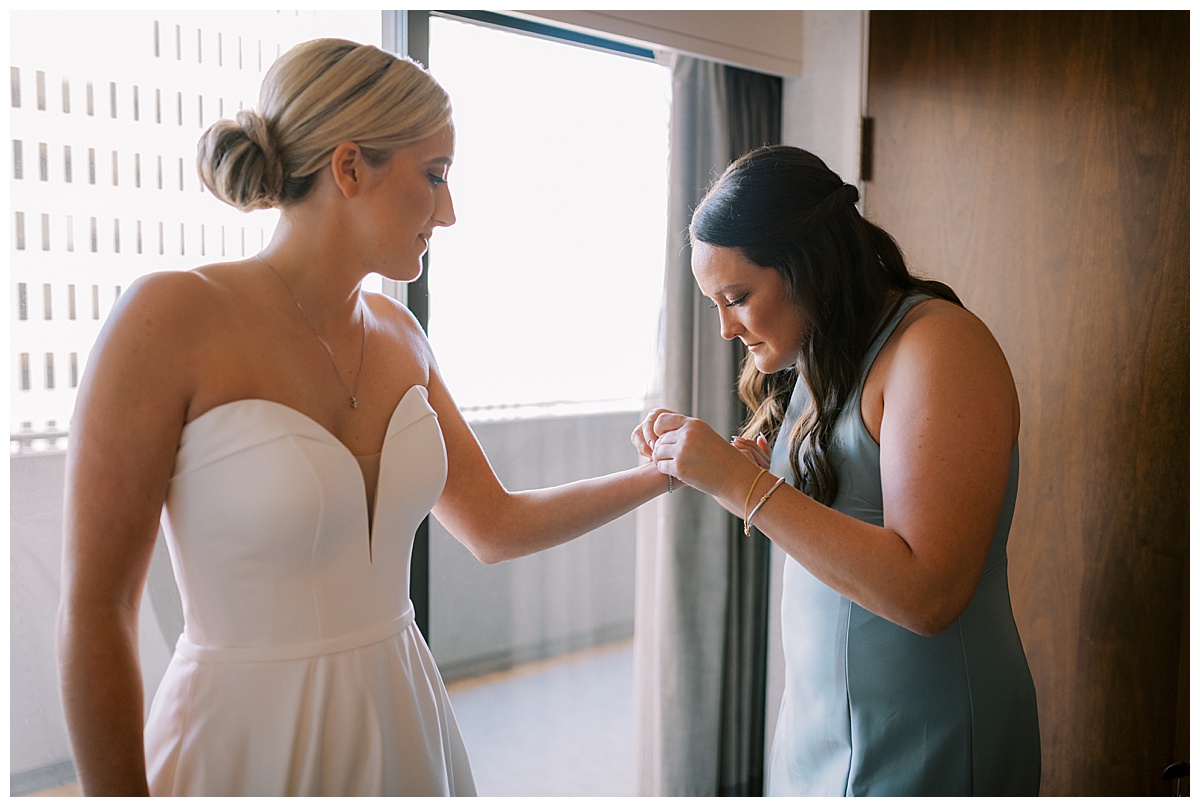Susie getting help putting on a bracelet for the wedding