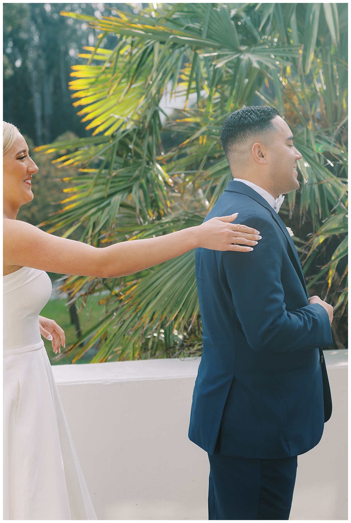 Susie tapping on Devon's shoulder for their first look before their wedding ceremony