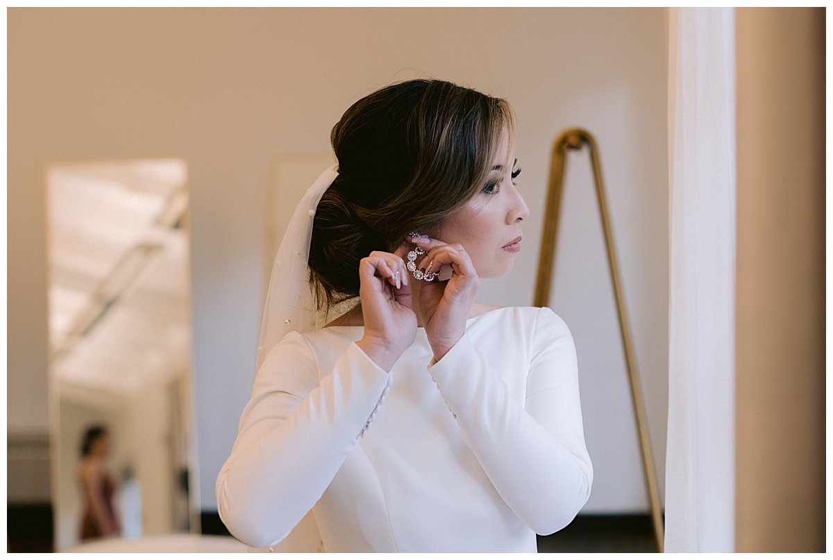 Vivian putting on her bridal jewelry