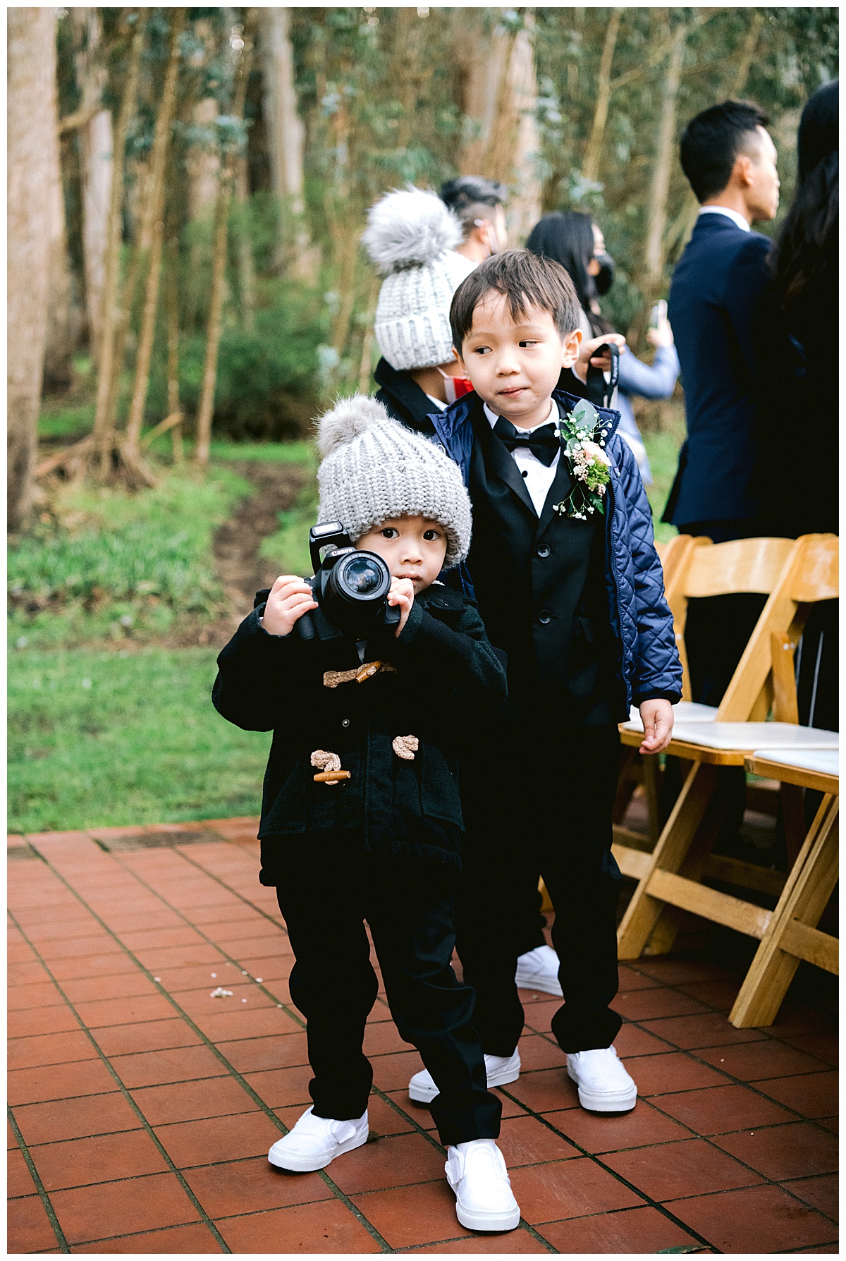 Tiny photographers before the outdoor Presidio Chapel wedding ceremony