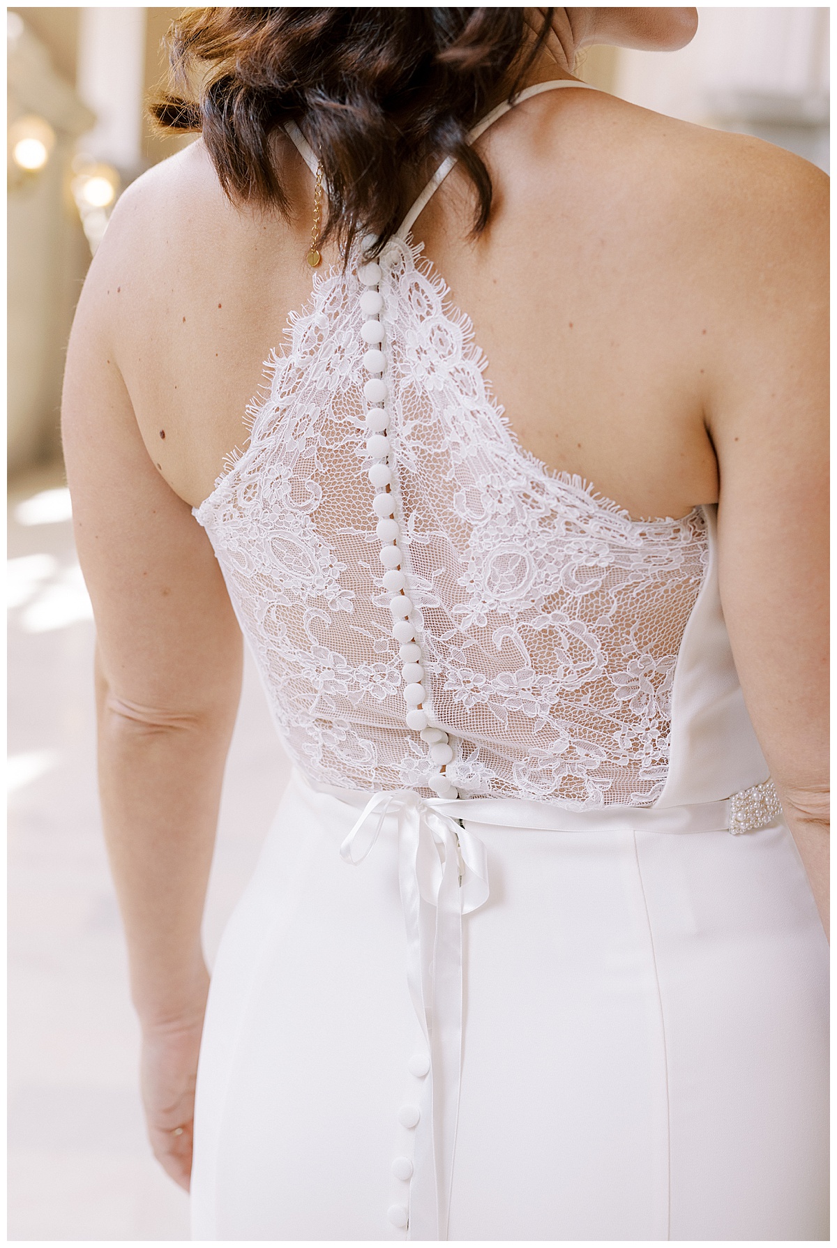 Detail shot of Hillary's lace wedding dress back