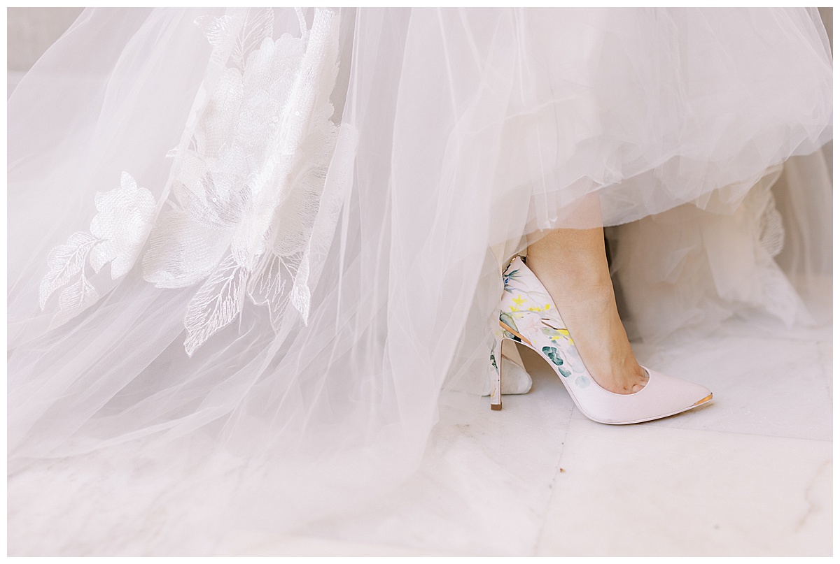 Detail shot of Mary's shoes and hem of her bridal gown