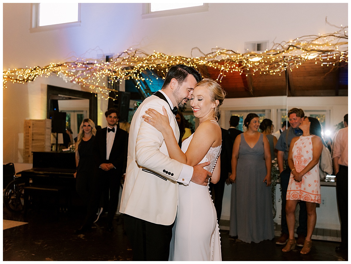 bride and groom first dance under twinkle lights
