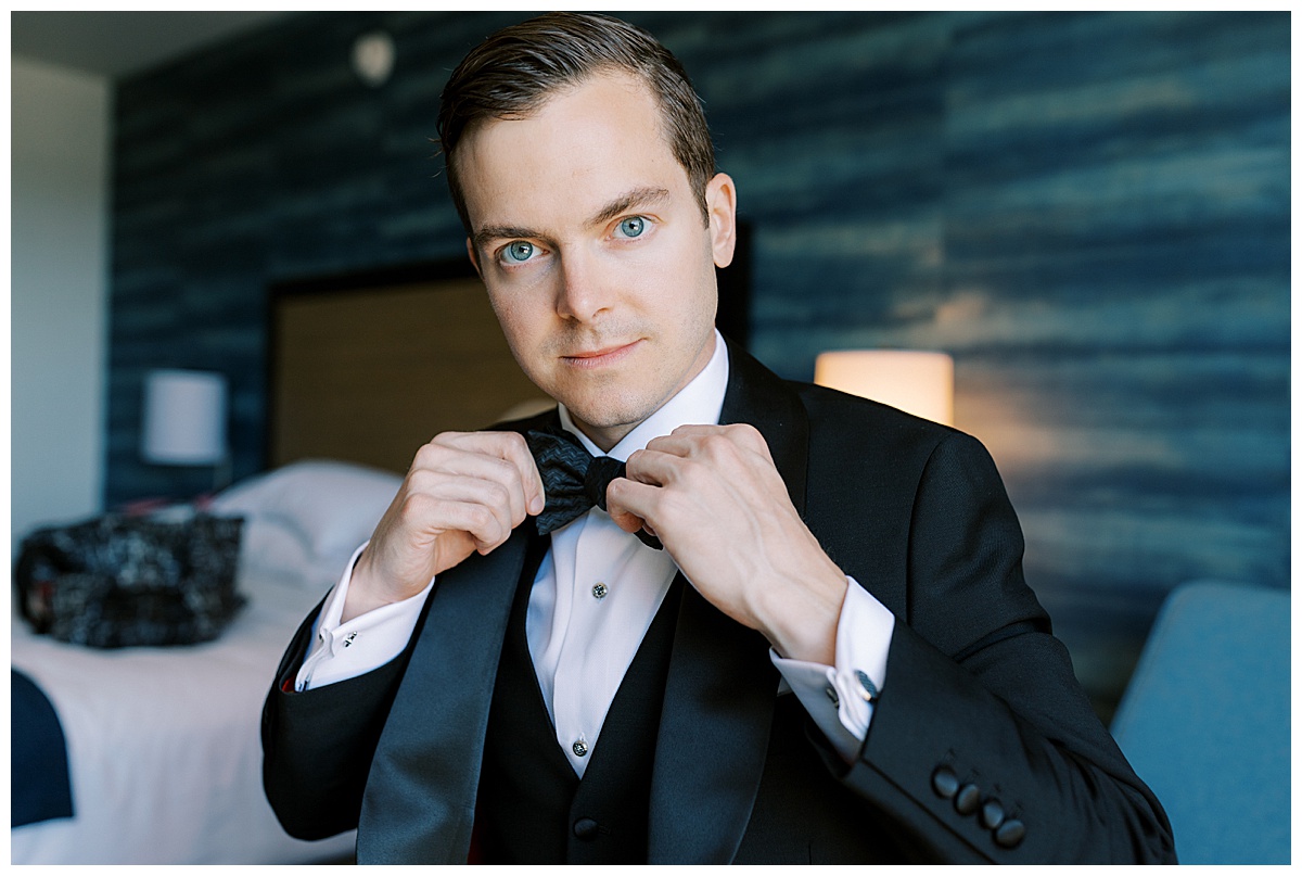 Groom getting ready at flood mansion