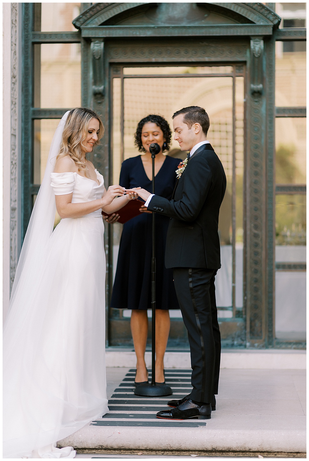 bride and groom exchanging rings at flood mansion 