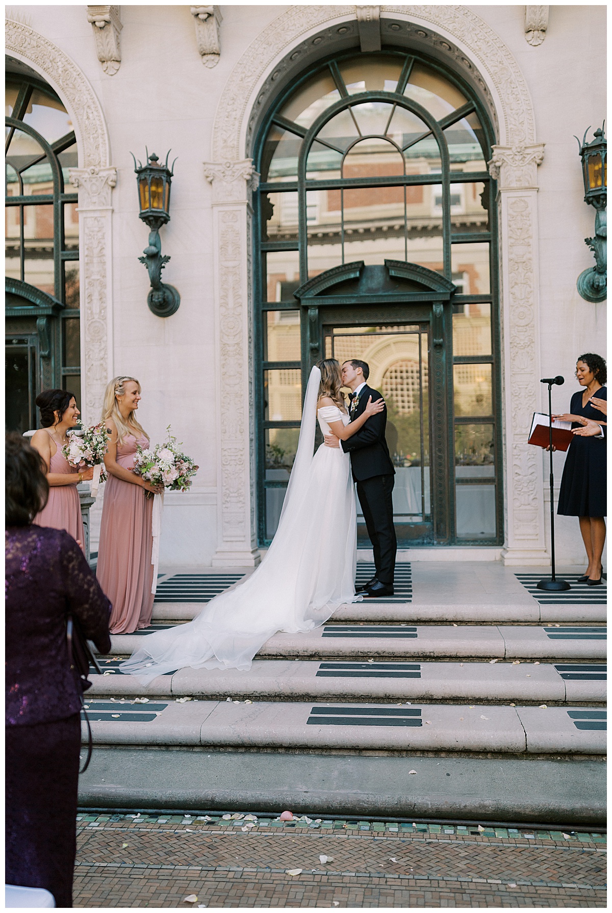 bride and groom share first kiss at flood mansion