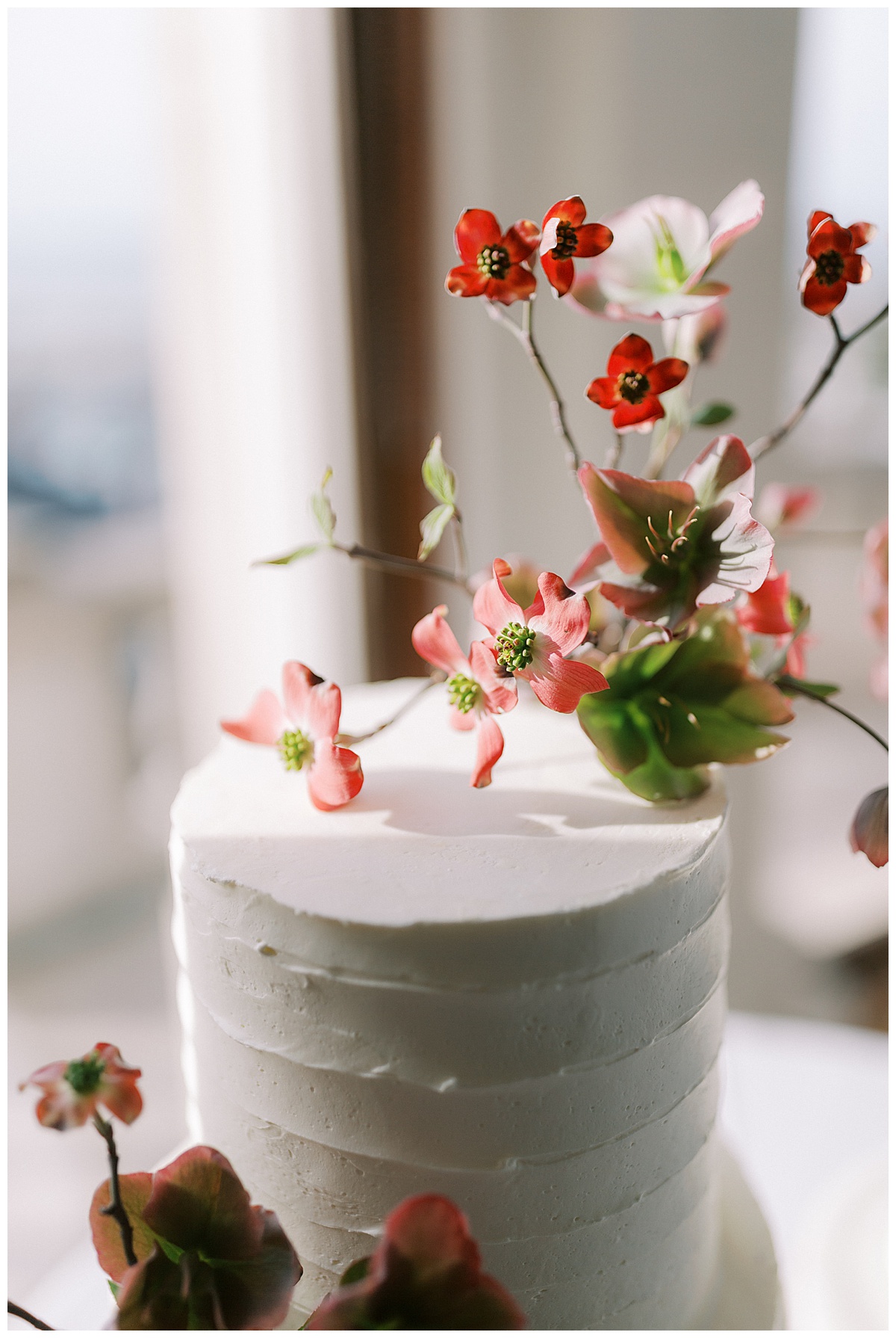 white wedding cake with fresh flowers