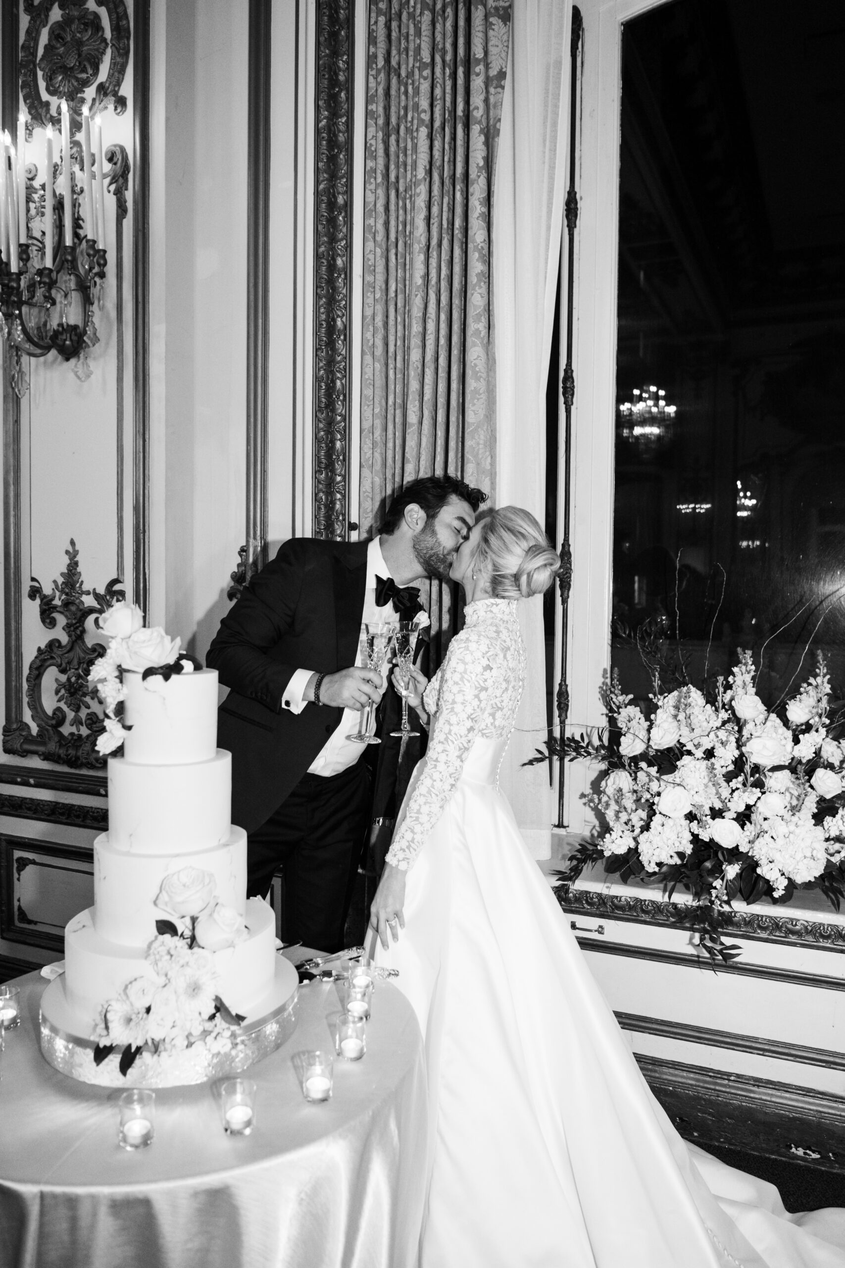 couple kissing after cutting wedding cake Fairmont San Francisco