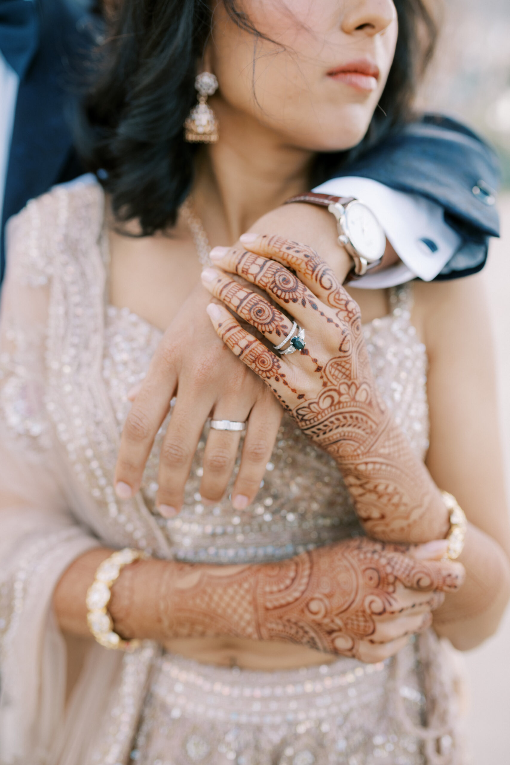 close up of couples hands with bridal henna