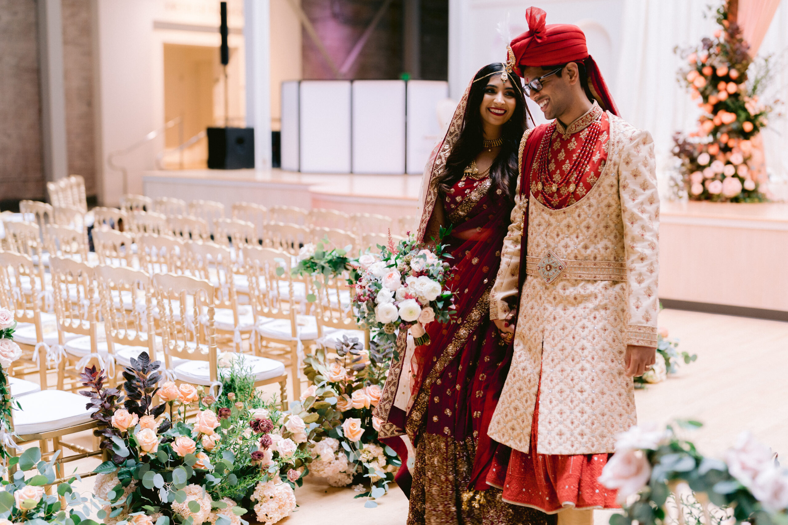 married Indian couple waking down isle at San Francisco design center galleria
