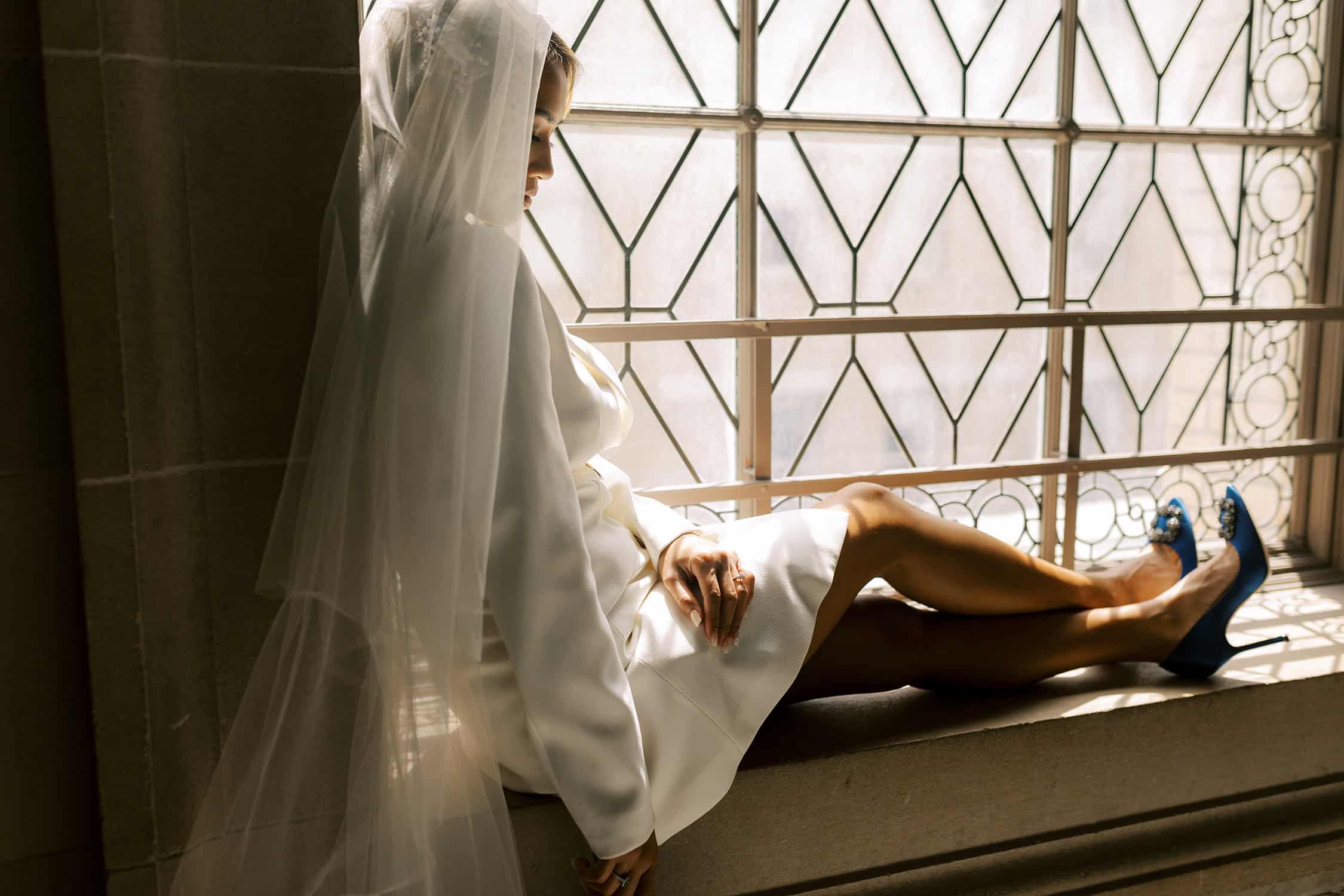 bride sitting in window at San Francisco city hall
