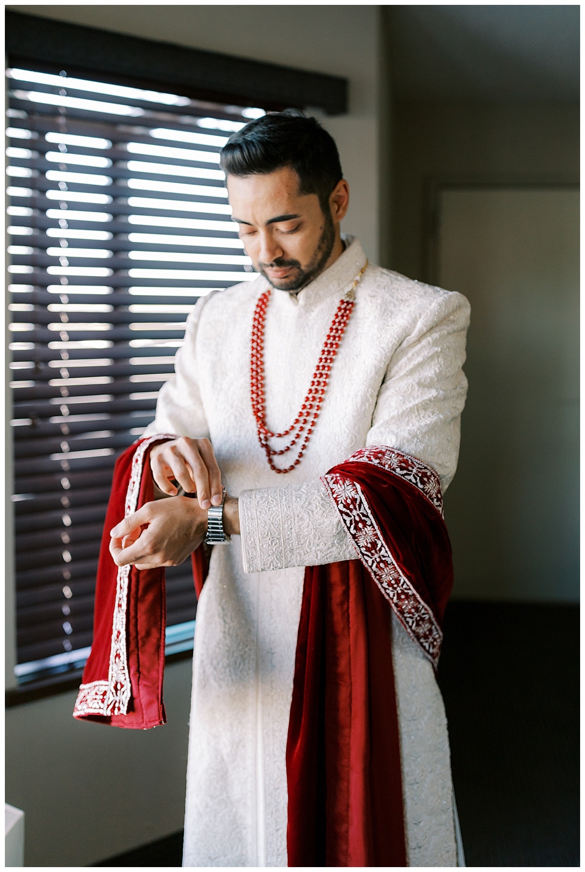 indian groom getting ready at hotel 