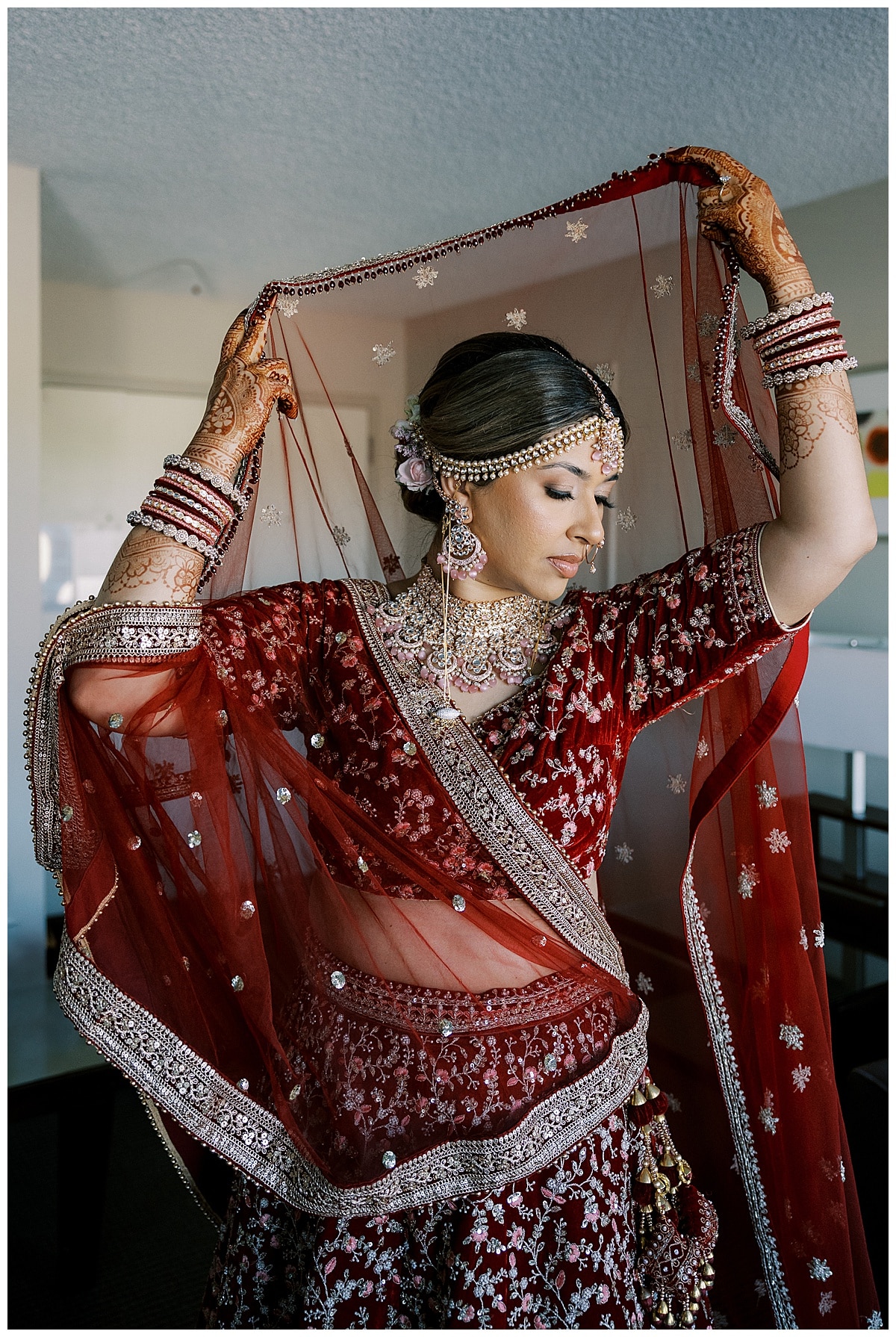 indian bride holding veil above her head