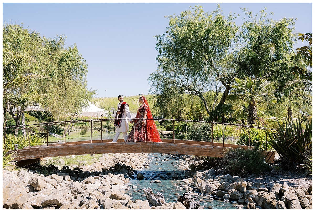 bride and groom crossing bridge at nella terra