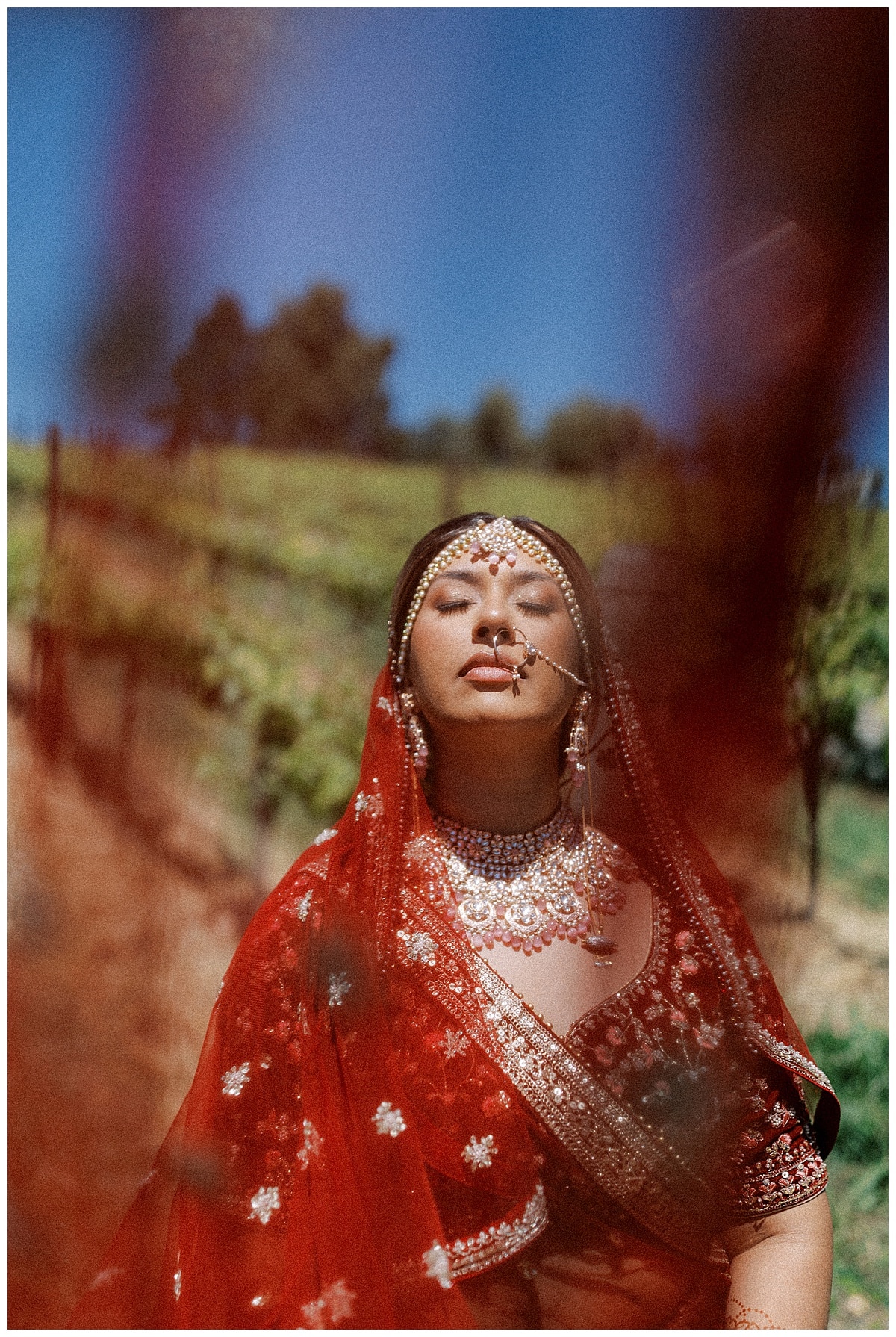 indian bride behind red veil