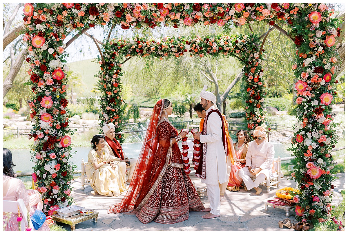 Indian bride and groom exchanging garlands during ceremony