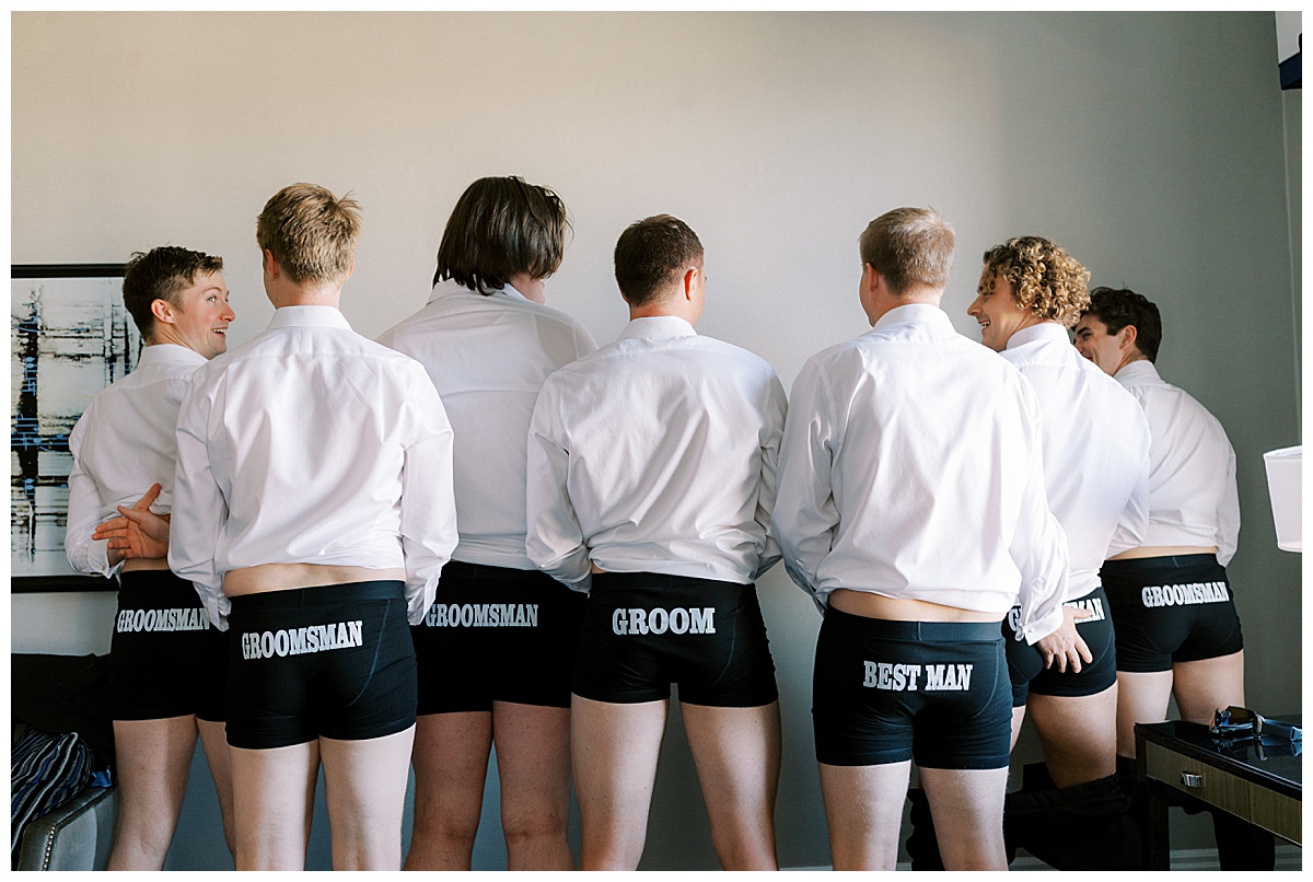 Groomsmen form behind all wearing matching boxers that say Groom, Groomsman, or Best Man