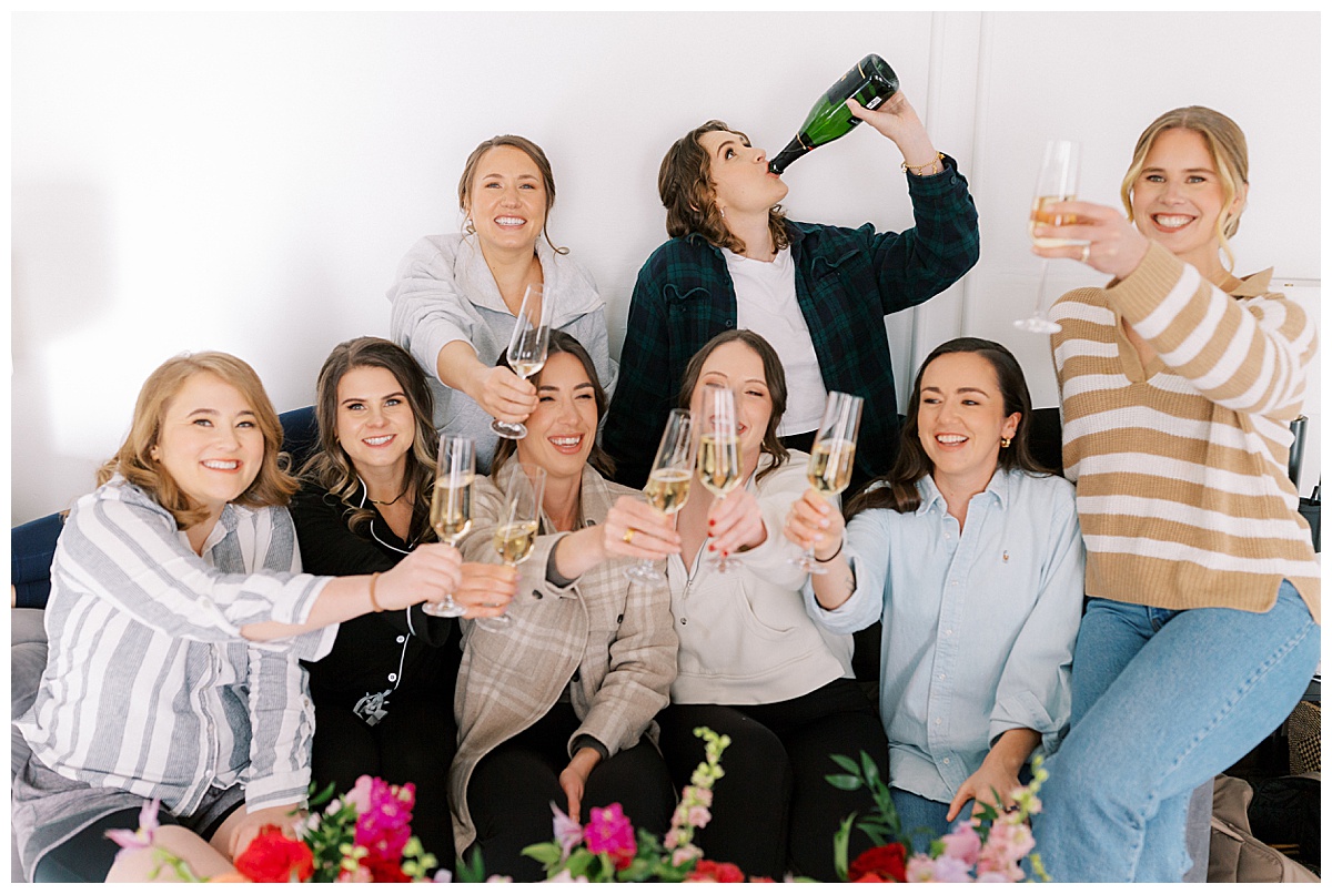 Bridesmaids and brides toasting before getting ready for a wedding