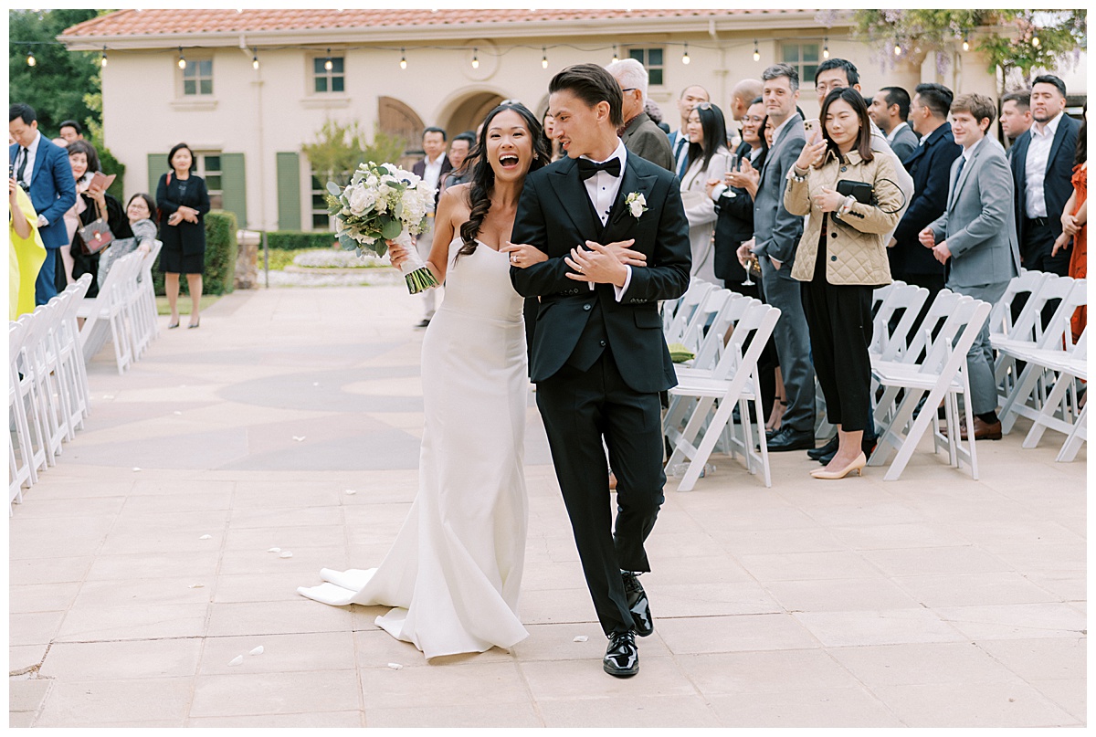 couple exiting after ceremony at the club at ruby hill