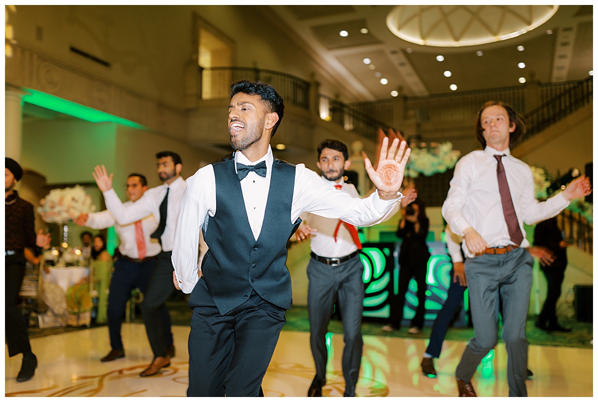 groom with groomsmen performing a dance during their wedding reception at the club at ruby hill