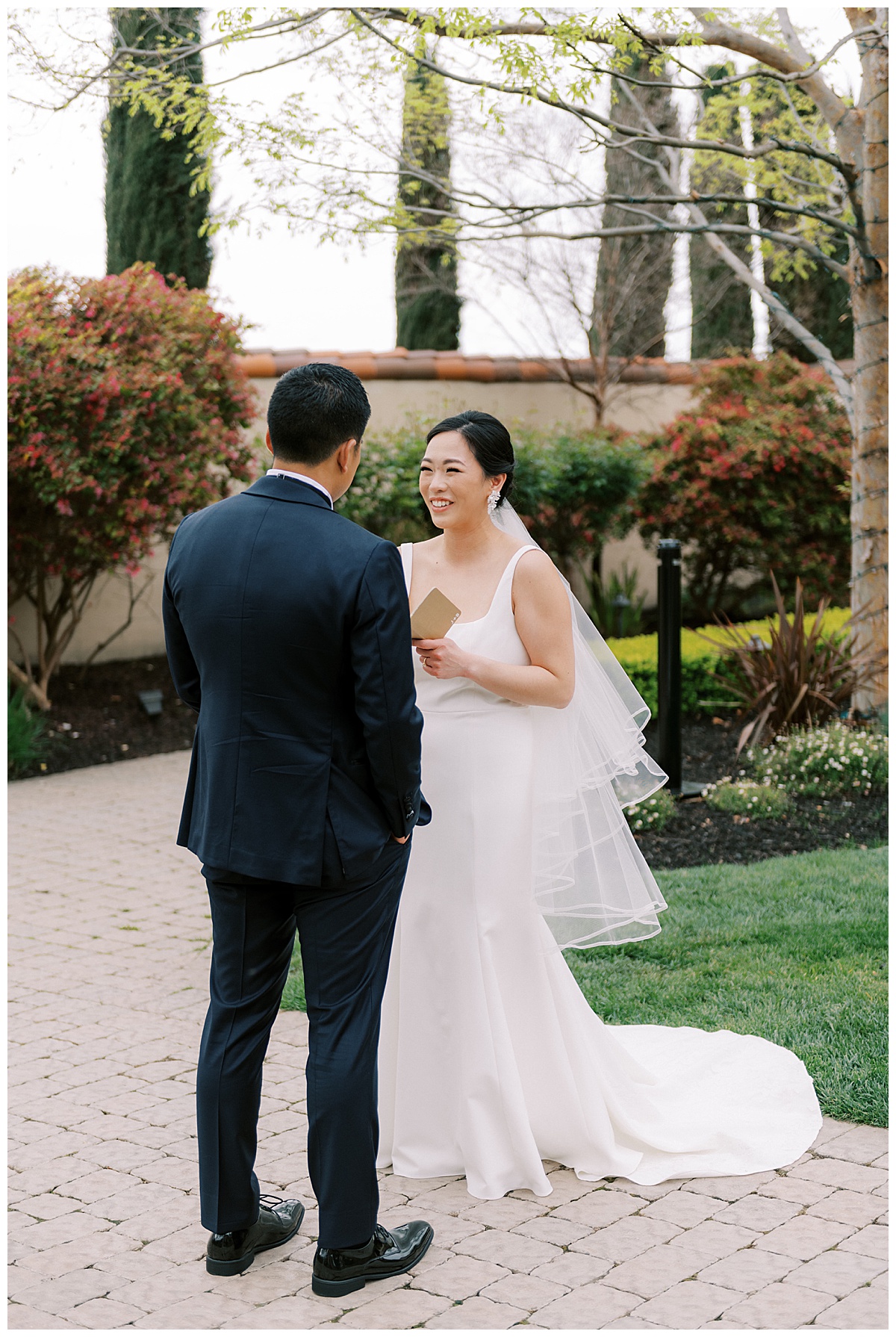 bride laughing while reading private vows to groom before their ceremony at casa real