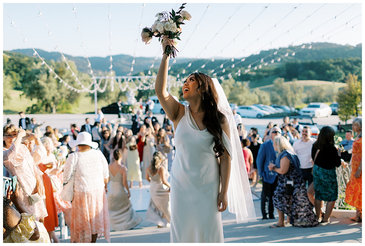 bridal bouquet toss outside of willow heights mansion