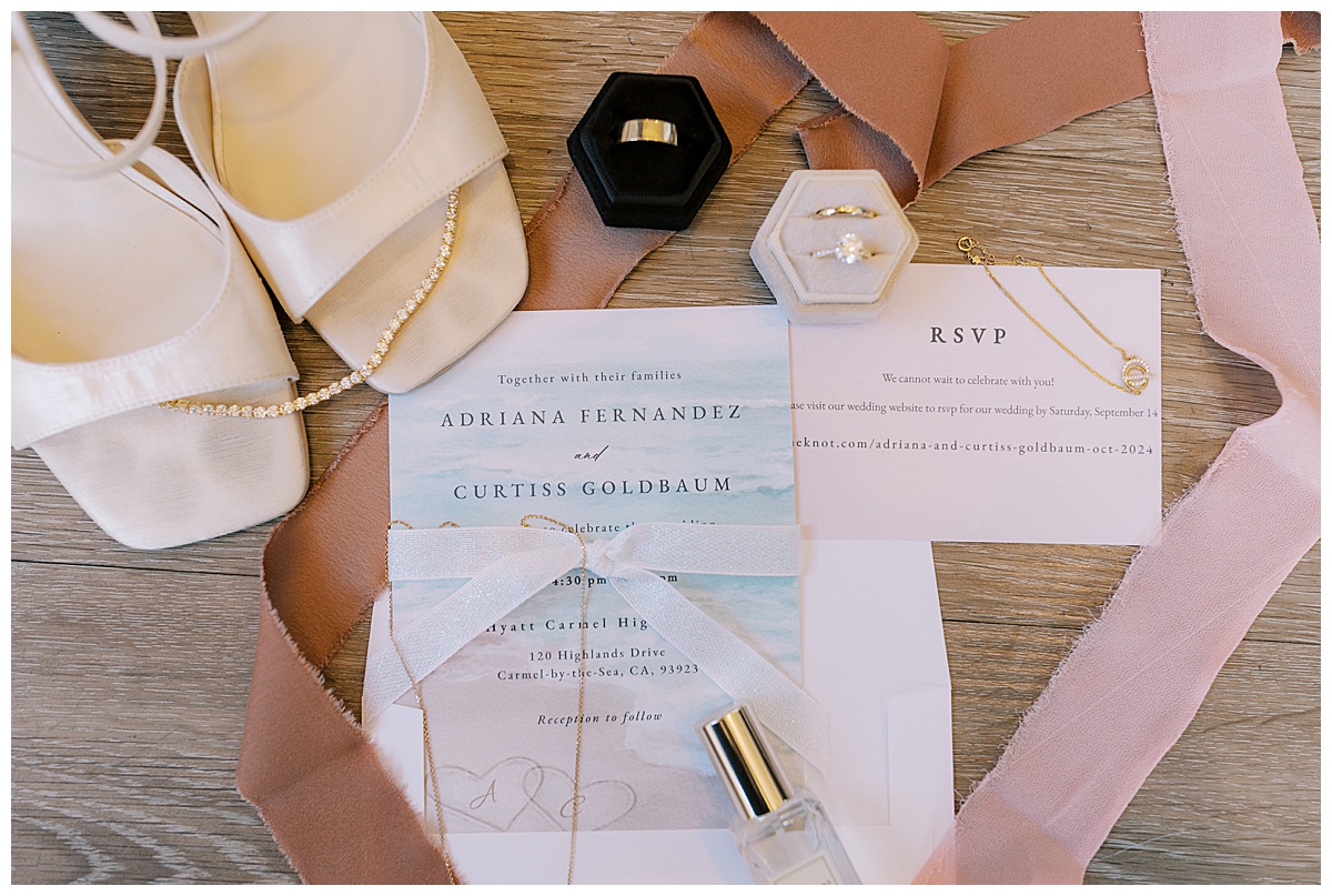lay flat details photo of invitations and jewelry