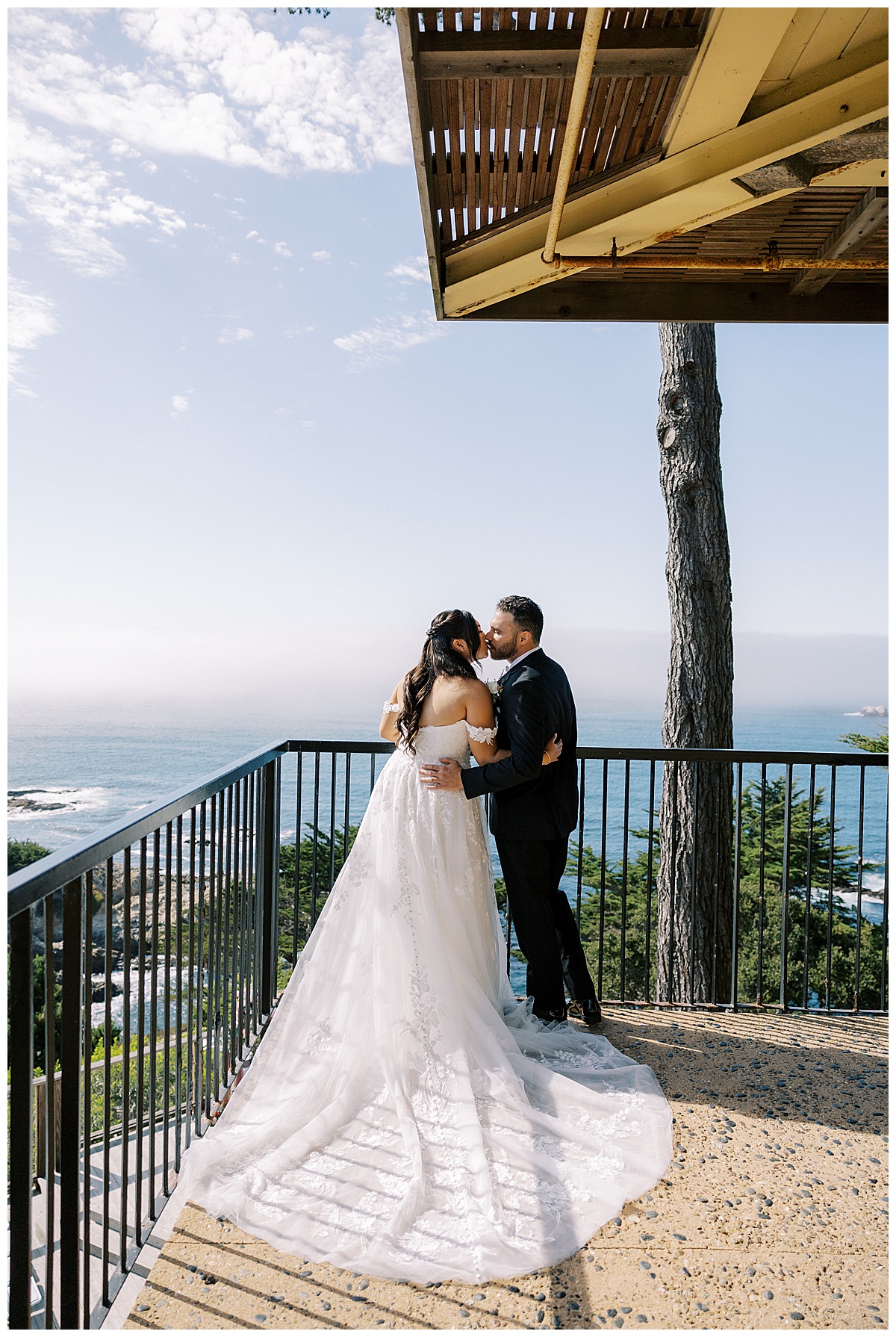 couple kissing on balcony of carmel highlands Hyatt