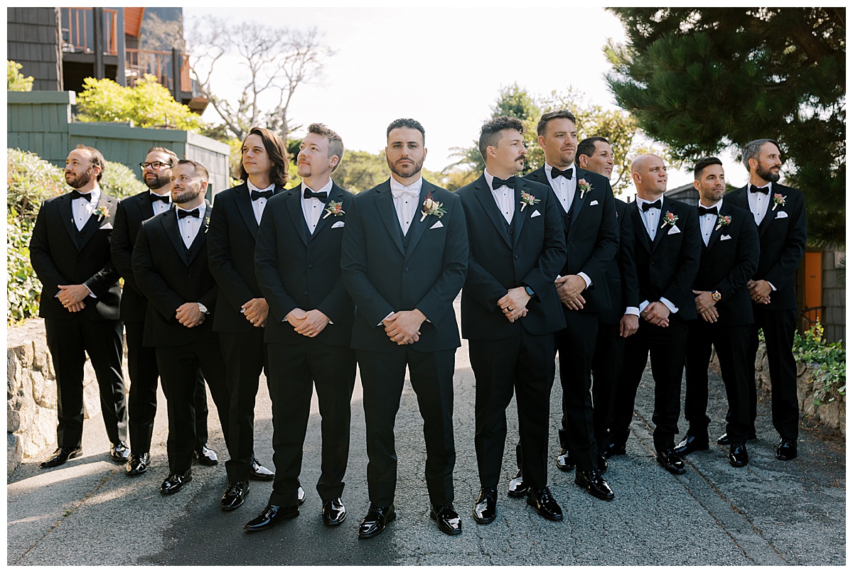 groom with his groomsmen standing in a V formation at carmel highlands Hyatt