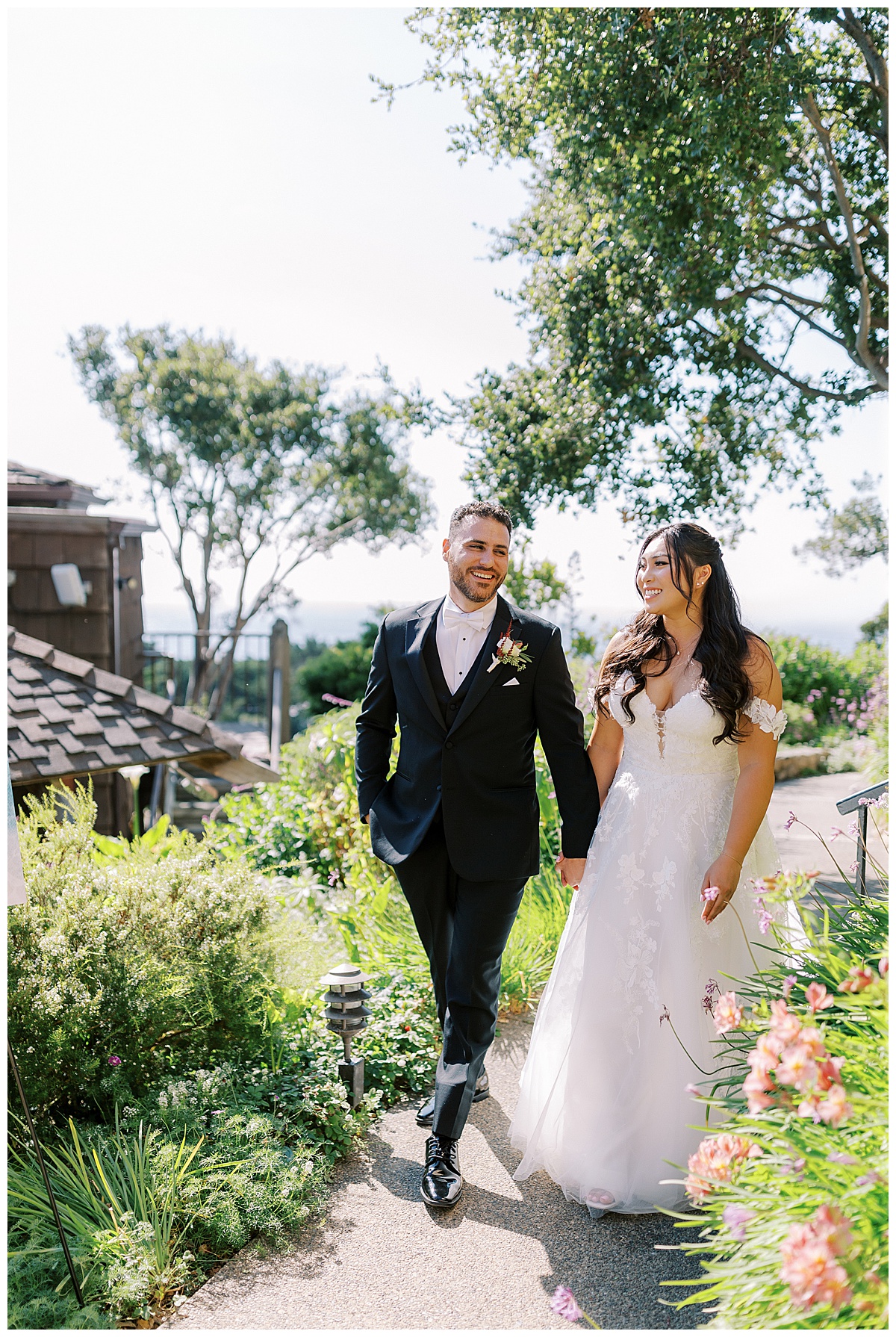 couple is laughing while walking down a garden path at carmel highlands Hyatt