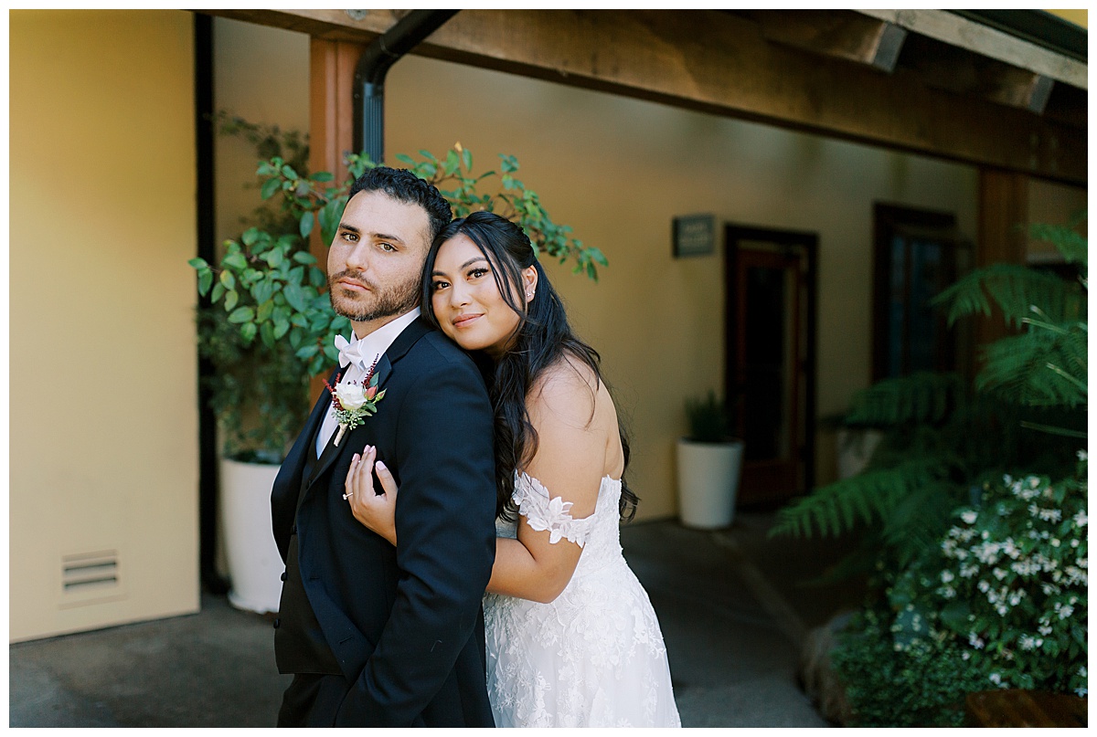 bride hugs groom from behind at carmel highlands Hyatt 