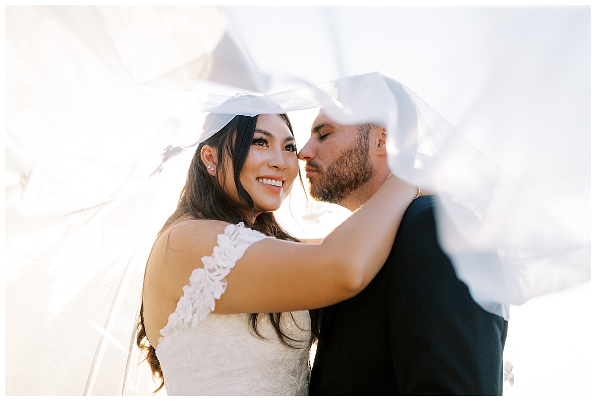 bride and groom under the veil at carmel highlands Hyatt