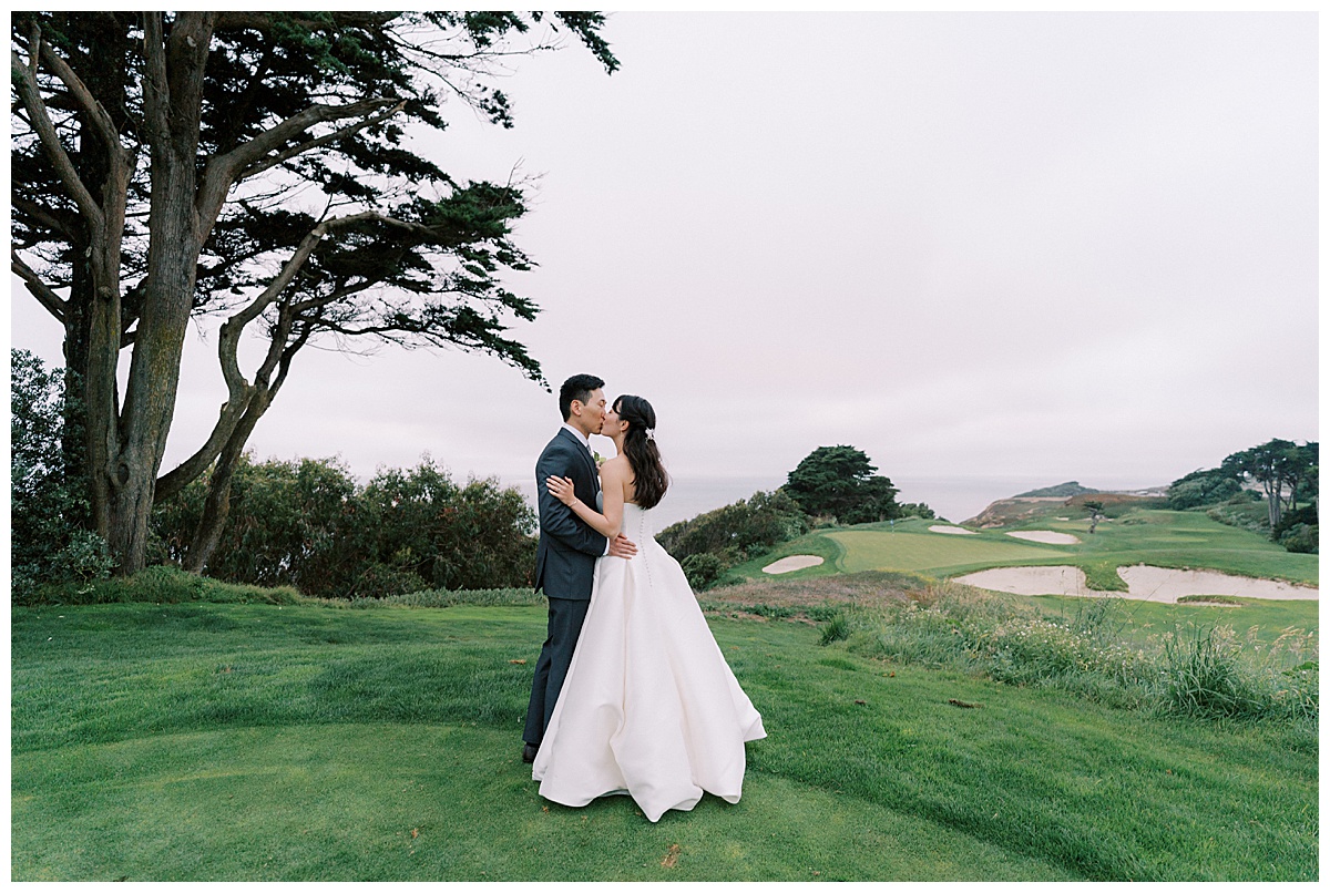 couple kissing at sunset outside of the olympic club in San Francisco